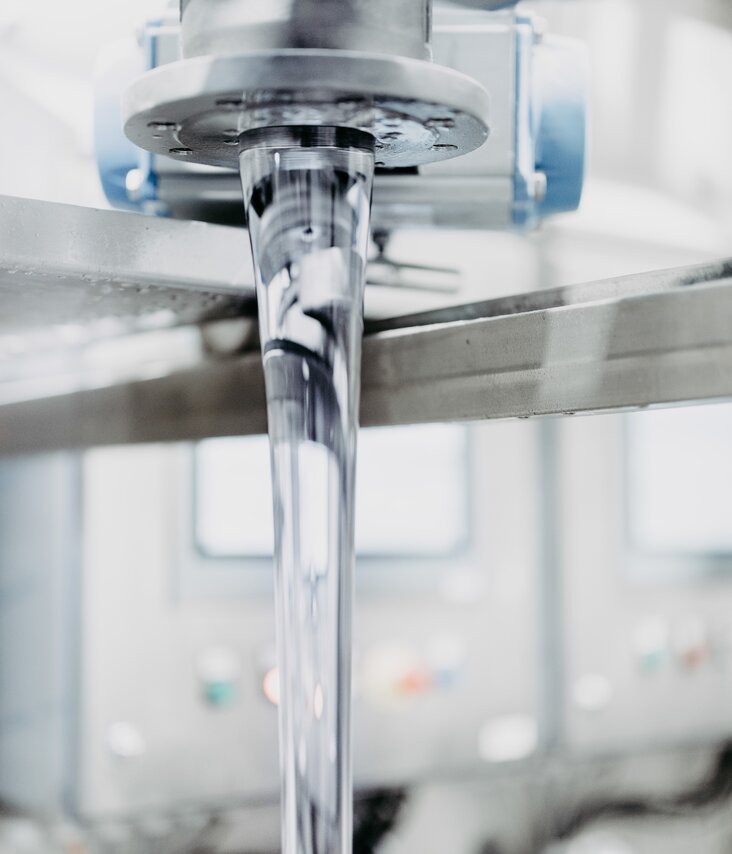 Adhesive flowing from a metallic machine. 