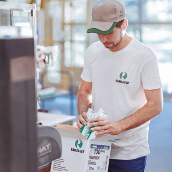 Ramsauer employee in production packing sealant cartridges. 