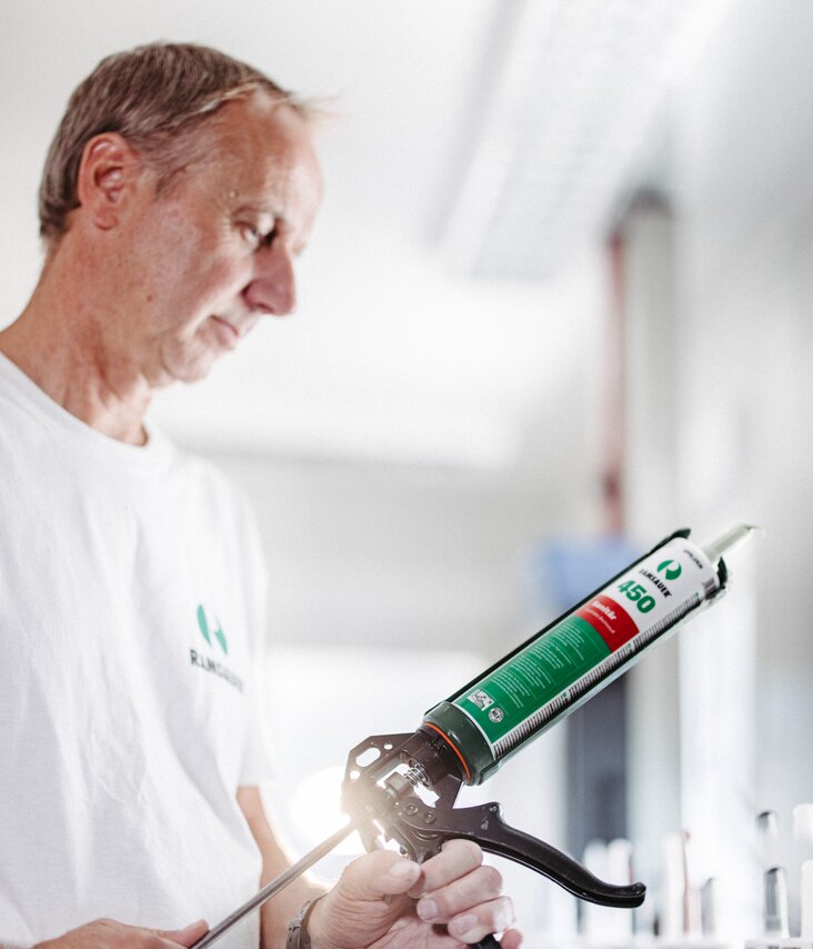 Ramsauer employee preparing sealant cartridge for application.